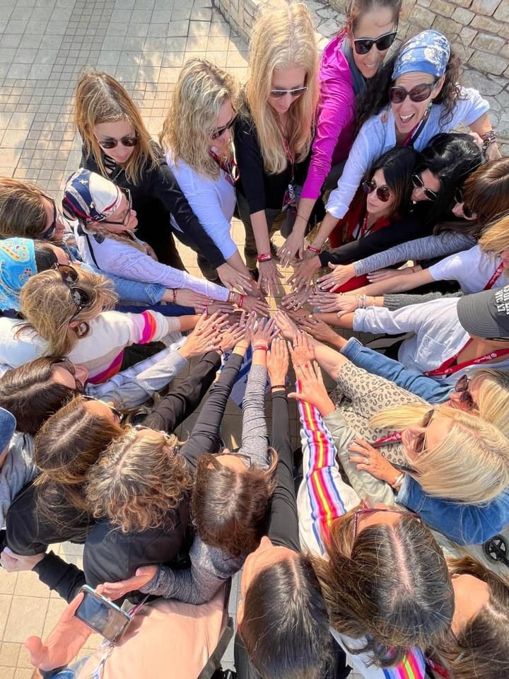 Members of the Jewish Community Collective joining hands together in a circle